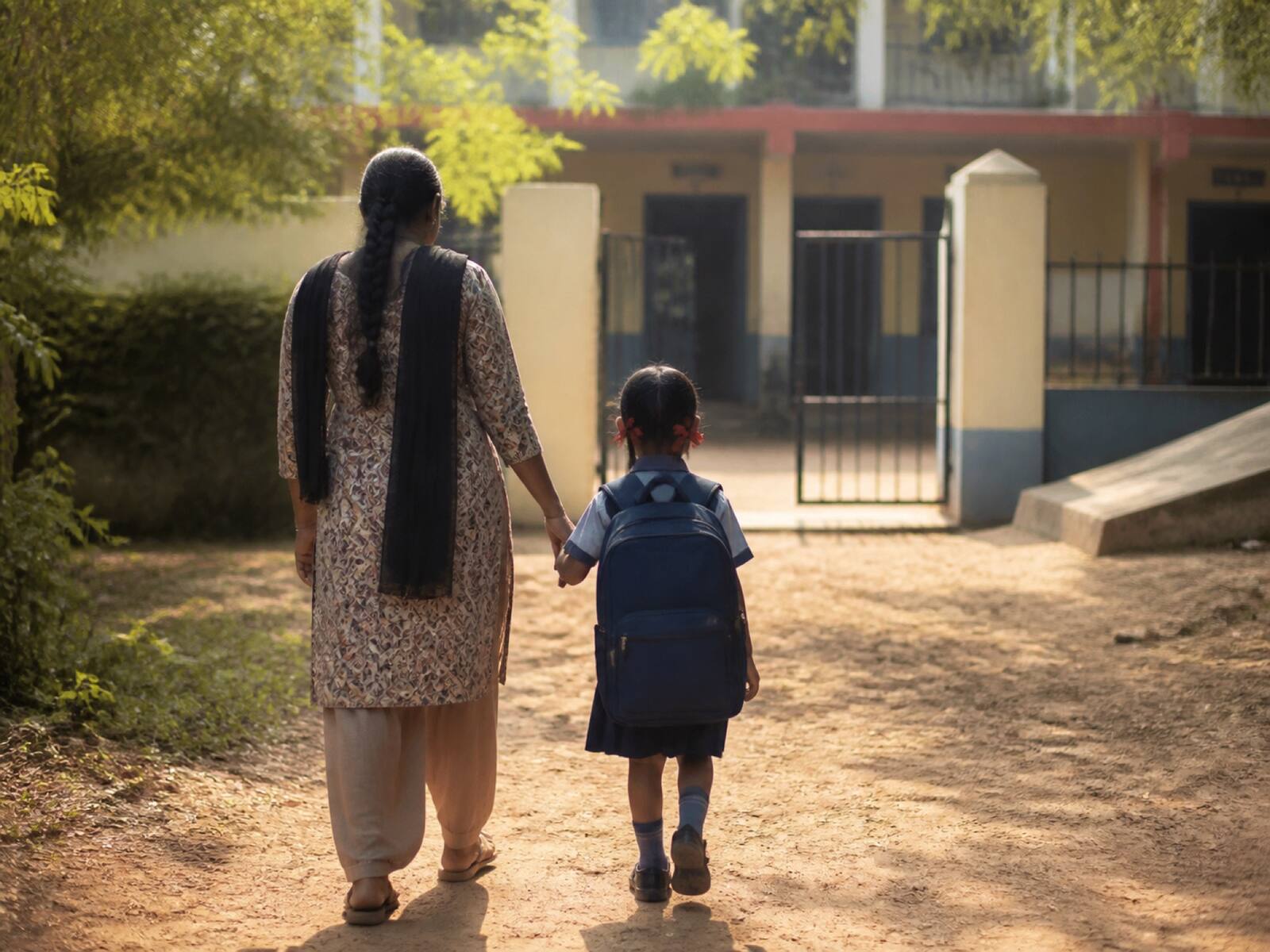 A child walking with a caregiver